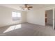 Bright bedroom with plush carpeting, a ceiling fan, and ensuite bathroom at 9705 E Butte St, Mesa, AZ 85207