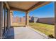 Relaxing covered patio with concrete flooring, a view of the backyard, and backyard shed at 9705 E Butte St, Mesa, AZ 85207