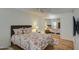 Bright bedroom featuring a flat-screen TV, mirrored closet doors, and a queen-sized bed with floral comforter at 9806 W Long Hills Dr, Sun City, AZ 85351