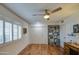 Bright bedroom with hardwood floors, large window, closet, bookcase and a stylish desk at 9806 W Long Hills Dr, Sun City, AZ 85351