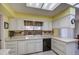 Well lit kitchen with white cabinets and neutral countertops at 9806 W Long Hills Dr, Sun City, AZ 85351