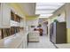 Bright kitchen with skylight features white cabinets and stainless steel refrigerator at 9806 W Long Hills Dr, Sun City, AZ 85351