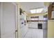 Bright kitchen with skylight, white cabinets, and black dishwasher at 9806 W Long Hills Dr, Sun City, AZ 85351