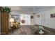 Bright living room with neutral carpet and view into dining area with lots of natural light at 9806 W Long Hills Dr, Sun City, AZ 85351