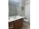 Bathroom with a vanity, toilet, framed mirror, and walk-in shower at 11000 N 77Th Pl # 1072, Scottsdale, AZ 85260