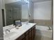 Bathroom with double sinks, a soaking tub, and a shower with a glass door at 11000 N 77Th Pl # 1072, Scottsdale, AZ 85260