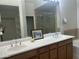 Bathroom with double sinks, a soaking tub, and a shower with a glass door at 11000 N 77Th Pl # 1072, Scottsdale, AZ 85260