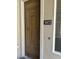 Elegant wooden front door featuring decorative panels and a modern number plaque, adding curb appeal at 11000 N 77Th Pl # 1072, Scottsdale, AZ 85260