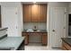 A kitchen desk area featuring wood cabinets, granite countertops, and two doors at 11000 N 77Th Pl # 1072, Scottsdale, AZ 85260