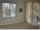 Living room featuring a window and sliding glass door leading to a balcony at 11000 N 77Th Pl # 1072, Scottsdale, AZ 85260