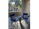 The patio has two blue camping chairs with cushions and a plant in the middle at 11000 N 77Th Pl # 1072, Scottsdale, AZ 85260