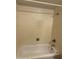 Full bathroom with beige tiled walls, a bathtub, showerhead and towel rack at 1111 E Village Circle N Dr, Phoenix, AZ 85022