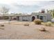 View of a single story home with unique desert landscaping and covered parking at 1111 E Village Circle N Dr, Phoenix, AZ 85022
