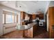 Spacious kitchen with island, wood cabinets, tile floor, and bay window with seating area at 1111 E Village Circle N Dr, Phoenix, AZ 85022