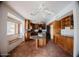 Large kitchen with wrap-around counter space, a breakfast nook, and a ceiling fan at 1111 E Village Circle N Dr, Phoenix, AZ 85022