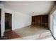 Spacious living room featuring a ceiling fan, built-in shelving, and sliding glass door at 1111 E Village Circle N Dr, Phoenix, AZ 85022