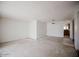 Spacious living room area with neutral walls, and view to kitchen at 1111 E Village Circle N Dr, Phoenix, AZ 85022