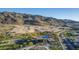 Expansive aerial view showcases new home construction with mountain views in a Primary-planned desert community at 1115 E Mcneil St, Phoenix, AZ 85042