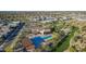 Scenic aerial view of a vibrant community with a pool, amenity center, and lush desert landscape at 1115 E Mcneil St, Phoenix, AZ 85042