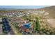 Aerial view of a modern community with pool, amenity center, green spaces, and surrounding homes at 1115 E Mcneil St, Phoenix, AZ 85042