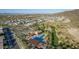 Beautiful aerial view of neighborhood clubhouse and pool amidst lush green landscape and desert terrain at 1115 E Mcneil St, Phoenix, AZ 85042