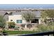 Landscaped backyard with desert plants, green grass, and a view of the city at 1115 E Mcneil St, Phoenix, AZ 85042