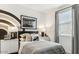 Modern bedroom featuring stylish striped bedding, monochrome accents, and natural light from a window at 1115 E Mcneil St, Phoenix, AZ 85042