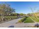 Scenic walkway with lush landscaping and shade structures, creating a beautiful and inviting community space at 1115 E Mcneil St, Phoenix, AZ 85042