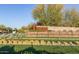 Community entrance with stone signage surrounded by manicured desert landscaping at 1115 E Mcneil St, Phoenix, AZ 85042