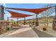 Comfortable outdoor space with shade canopies, seating, and beautiful landscaping at 1115 E Mcneil St, Phoenix, AZ 85042