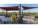 Relaxing outdoor area with shade canopies and comfortable benches surrounded by lush landscaping at 1115 E Mcneil St, Phoenix, AZ 85042