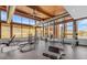 Well-equipped gym with exercise machines and scenic desert views through large picture windows at 1115 E Mcneil St, Phoenix, AZ 85042