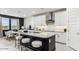 Modern kitchen featuring white cabinetry, dark countertop, stainless steel range hood and an island at 1115 E Mcneil St, Phoenix, AZ 85042