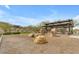 Community park area offers rocks for climbing under a covered structure, set against a backdrop of desert vegetation at 1115 E Mcneil St, Phoenix, AZ 85042