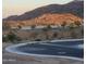 Scenic street view with desert landscaping and mountain backdrop at sunset in a new community at 1115 E Mcneil St, Phoenix, AZ 85042