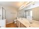 Bathroom featuring double sink vanity and shower with glass door at 11328 N 89Th Dr, Peoria, AZ 85345