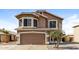 Charming two-story home features a two-car garage and desert landscaping at 11328 N 89Th Dr, Peoria, AZ 85345