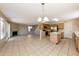 Open-concept living room showcasing stainless steel appliances and tiled flooring at 11328 N 89Th Dr, Peoria, AZ 85345