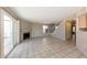 Open-concept living room with tiled floors, a fireplace and staircase to the second floor at 11328 N 89Th Dr, Peoria, AZ 85345