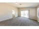 Bright living room with plush carpet, sliding glass door, and neutral paint at 11328 N 89Th Dr, Peoria, AZ 85345