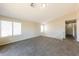 Spacious loft area with carpet flooring and natural light from bright windows at 11328 N 89Th Dr, Peoria, AZ 85345