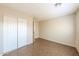 Bedroom featuring a closet, tile floors, and neutral paint at 11609 W Corrine Dr, El Mirage, AZ 85335