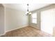 Dining room features tile floors, chandelier, and a sliding glass door providing natural light at 11609 W Corrine Dr, El Mirage, AZ 85335