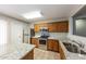 Kitchen with stainless steel appliances, granite counters, tile floors, and oak cabinets at 11609 W Corrine Dr, El Mirage, AZ 85335