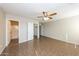 Spacious main bedroom featuring tile flooring, ceiling fan, and a view of the bathroom and closet at 11609 W Corrine Dr, El Mirage, AZ 85335