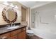 Bathroom featuring granite counters, wood cabinets, and a shower-tub combination, providing both style and functionality at 12530 W Skylark Dr, Sun City West, AZ 85375