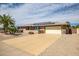 Single story home featuring desert landscaping, solar panels and a large driveway at 12530 W Skylark Dr, Sun City West, AZ 85375