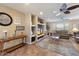 Living room featuring built-in shelving, ceiling fan and plush couches at 12530 W Skylark Dr, Sun City West, AZ 85375