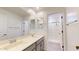 Bright bathroom featuring dual sinks, vanity with storage, and a walk-in shower at 14420 W Faye Way, Surprise, AZ 85387