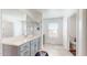 A bathroom featuring a single sink vanity, tile flooring, and natural light at 14420 W Faye Way, Surprise, AZ 85387